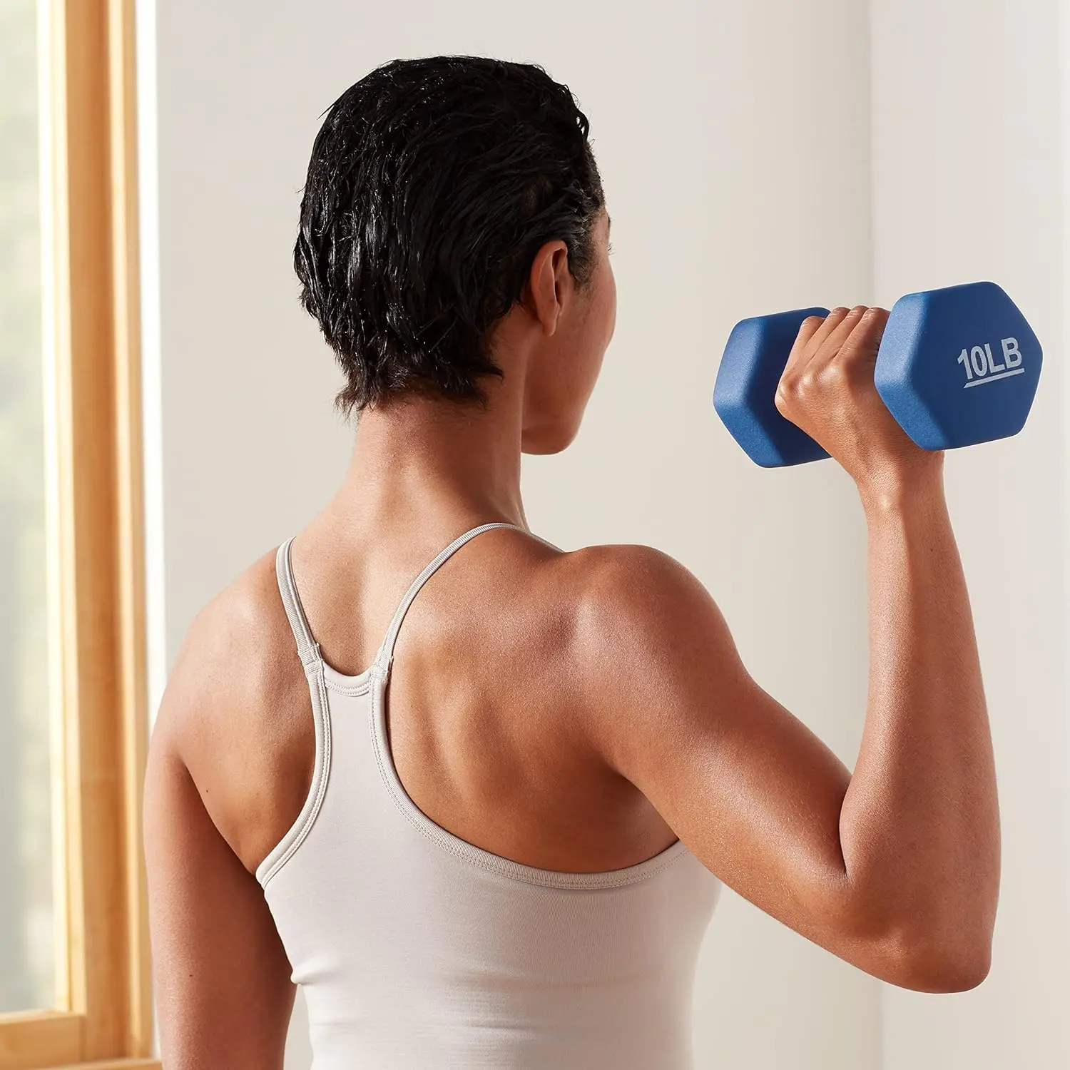 Woman training with 10LB blue dumbbells